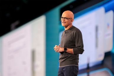 A photo of Satya Nadella, Microsoft chairman and CEO, smiling while speaking on stage at the Microsoft Build 2025 conference in Seattle.