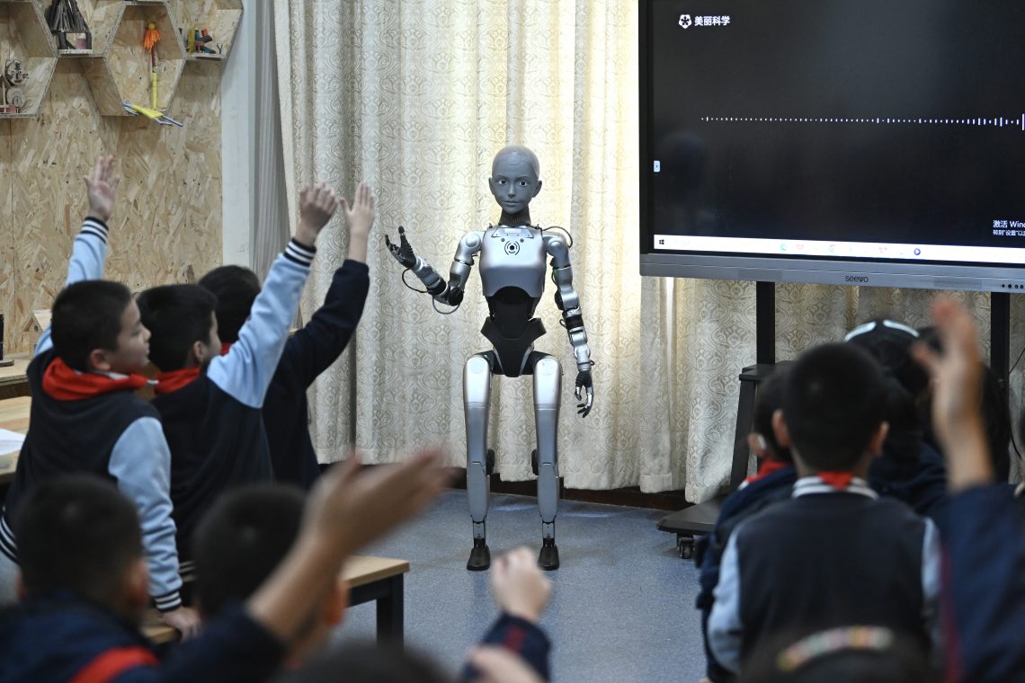 Oct. 27, 2025, Hefei, China: Students listen to a humanoid robot. The science class was taught by “Xiao An,” a 1.4 meter-tall humanoid robot serving as a teaching assistant.
